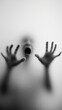 © Alex Photography - A blurred figure with raised hands leans against frosted glass, evoking mystery and suspense in eerie monochrome.