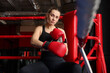 © New Africa - Woman sitting in her corner of boxing ring