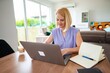 © Jelena - Focused woman working on her laptop at home office