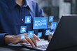 © Pakin - Employee benefits concept. Insurance, paid vacation, office perks, Fringe benefits for employee engagement. Businessman using laptop with employee benefits icon on virtual screen.