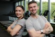 © New Africa - Portrait of personal trainers in sport center