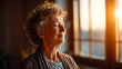 © Lumaverse - Peaceful senior woman with curly hair basking in the warm, golden glow of natural sunlight by a window, embracing a moment of calm and mindfulness at home, reflecting well-being