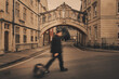 A tourist walking past the Bridge of Sighs in Oxford