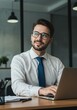 © DianneF - Photo of Young Businessman at Office Desk with Laptop and Blue Tie