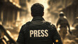© demzp - A journalist in a press vest walks into a warzone to report on the unfolding events.