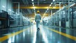 © Ketua - A worker in a yellow hard hat walks down the middle of a large industrial facility.