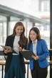 © Thitisak - Two young female businesswomen are meeting in an office.