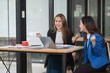 © Thitisak - Two young female businesswomen are meeting in an office.