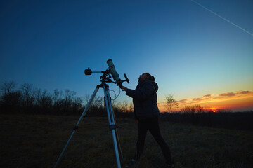 Wall Mural - amateur astronomer using telescope for watching stars, moon, planets and other celestial objects fro