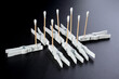 © dimas830 - Creative Composition of Cotton Swabs and Clothespins on Dark Background – Conceptual Everyday Art