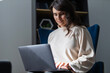 © Andrii Zastrozhnov - Young adult female using laptop in modern home office setting