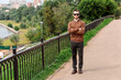© Алексей Петров - Happy young man in sunglasses standing on bridge with arms crossed and looking at camera