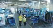 © Gorodenkoff - Two Engineers in Safety Vests Use a Tablet to Interact With Holographic Data in a High-tech Factory, Activate AI Facility Analysis, Advanced Machinery, Digital Interfaces, Futuristic Manufacturing