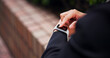 © peopleimages.com - Hands, business and person with smart watch in city to check time, corporate schedule and reading email. Tech, online and travel for communication, commute location and reminder notification in Japan