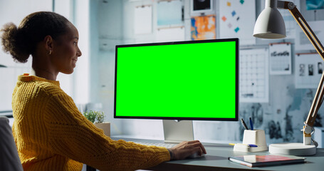 Aufkleber - Black Female Engineer Uses Desktop Computer With Green Screen Chroma Key. Modern Office Setup with Creative Entrepreneur doing Technical Work, Resulting in Productivity and Innovation