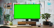 © Gorodenkoff - Desktop Computer Monitor on a Wooden Desk with a Green Screen Chroma key Mock Up Display. Office Working Station for Art, Enginering, Fashion, Architectural, Creative Agency. Template For Advertising