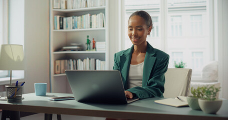 Aufkleber - African American Woman Works on Laptop in Bright Home Office. Radiant Smile Illuminates Her Face, Professional Success and Personal Fulfillment in Style and Productivity. Bright Apartment
