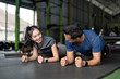 © Natee Meepian - Plank Challenge. Friends enjoying a fun workout challenge at the gym.