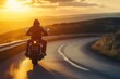 © Ольга Лукьяненко - Motorcyclist riding on winding mountain road at sunset