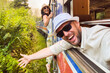 © Evaldas - Happy excited passenger travel couple stand by doorstep enjoy popular train ride journey Kandy to Ella and admire Sri lanka lush jungle landscapes. Embrace freedom, curiosity, wonder asia travel