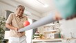© InfiniteFlow - Elderly man playing a ball rolling game with his partner at home, practicing hand-eye coordination, focus, and motor skills for mental and physical wellness. Preventing healthcare concept. Myrmidon.