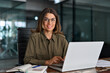 © insta_photos - Happy mature middle aged professional business woman investor working on laptop computer in office, portrait. Female smiling manager executive or attorney adviser looking at camera at workplace.