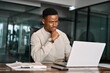 © insta_photos - Young male businessman looking at computer thinking on online investment or software technology. Busy professional African business man company employee using laptop working at office.