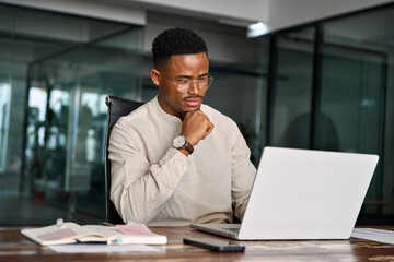 young male businessman looking at computer thinking on online investment or software technology. bus