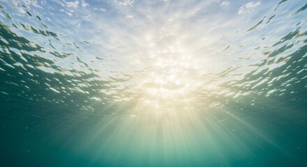Wall Mural - ocean surface from below, with ripples and sunbeams visible above