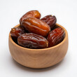 © SarminAkter - Sweet Medjool Dates in a Wooden Bowl on White Background