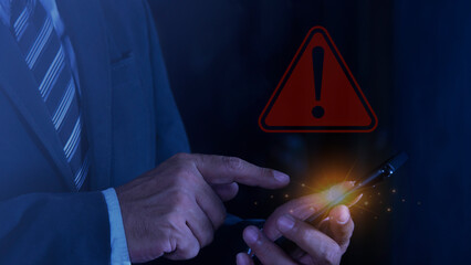 businessman using smartphone with warning sign. system warning caution sign for notification error a
