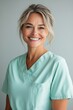 © Vero - Friendly nurse in a professional uniform, looking confident.