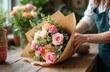 © Vadym - Female florist wraps bouquet roses in craft paper in flower shop. Woman creates floral arrangement, prepares for sale. Roses, plants, craft paper create beautiful decor, perfect gift. Business,