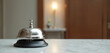 © Vadym - Close-up view of silver service bell on hotel reception desk. Bell alerts guests. Hospitality concept. Travel and tourism theme, vacation and holiday. Silver bell ring for assistance.