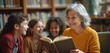 © miss irine - Senior woman reads book to children in library. Happy kids listen to story. Teacher, students enjoy literature time. Library background, warm yellow sweater. Education, knowledge, storytelling.