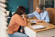 © Mediaphotos - Middle aged Caucasian female social worker comforting distressed young adult Caucasian woman in office setting, engaging in supportive conversation and providing emotional assistance