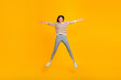 © Tetiana - Full size photo of cool brunette millennial lady jump wear shirt trousers isolated yellow color background