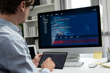 IT developer selecting by point on coding online software development information on tablet comparing with pc and laptop screen with new code program on update version overall system. Pecuniary.