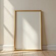 © miss irine - Mockup frame leans against wall, bedroom interior floor. Sunlight creates shadows. Empty picture frame template, minimalist art design for poster print. Wood floor, white wall. Home decor, blank