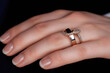 © Luminous Visions - A close-up showcases an elegant gold ring adorned with sparkling diamonds on a delicate hand.