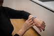 © Михаил Решетников - Elderly Caucasian woman looking at smart watch. Close-up of hands.