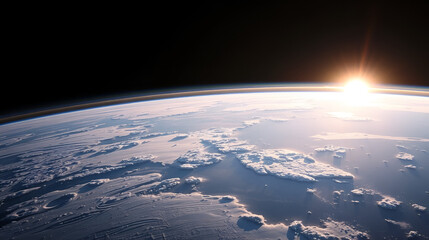 a view of the earth from space, with the sun rising over the horizon