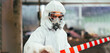 © NVB Stocker - Officials from the Department of Hazardous substances control bureau is investigating the leak of a hazardous chemical in chemical industry plant. Man with safety protective mask in factory