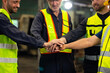 © NVB Stocker - team hands together. Professional team working at workplace. Unity and teamwork. Group portrait engineer factory manager worker and mechanic team together in factory workplace