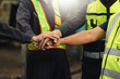 © NVB Stocker - team hands together. Professional team working at workplace. Unity and teamwork. Group portrait engineer factory manager worker and mechanic team together in factory workplace