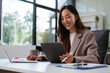 © NINENII - Businesswoman analyzing financial graphs, calculating company expenses, and planning investments, corporate, accounting, and economic strategy.
