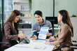 © Nuttapong punna - Group of Asian business meeting in planning design in creative business discussing work