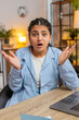 © Andrii Iemelianenko - Portrait of stress offended woman boring dissatisfied looking at camera shake head no rejection deny. Indian girl bored with work home office student stressful sad upset annoyed grimace. Vertical.
