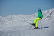© Sergey Novikov - Skier wear green jacket stand in funny pose on fresh ski slope