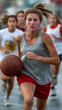 © ABF_MATEO - Focused young woman dribbles basketball ahead of teammates during practice, displaying her athletic prowess in team sport setting.